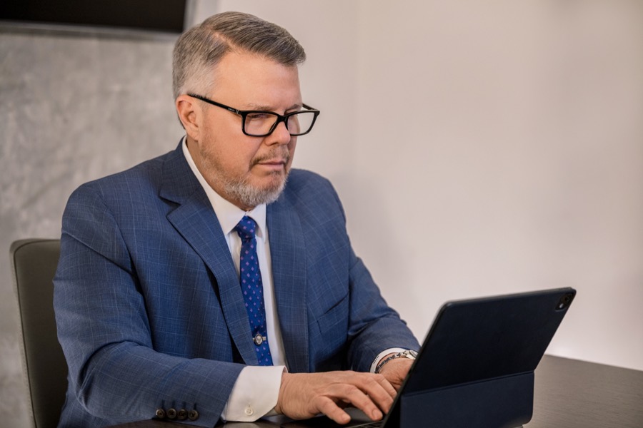 Joseph Graves reviewing case details on a tablet